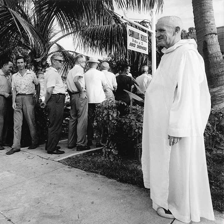 Brother Mathias Standing Next to Sign