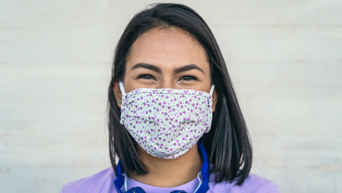 Young woman wearing face mask portrait - Latin girl using protective facemask for preventing spread of corona virus - Health care and pandemic crisis concept