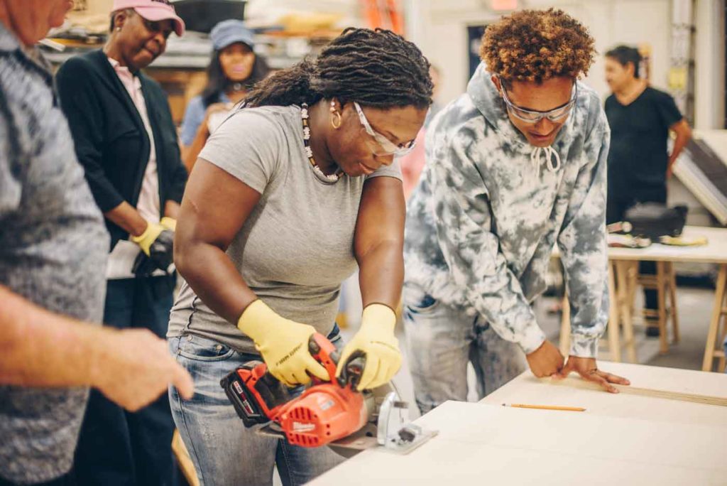 FIU-CH-client FIU Graduate operating a saw