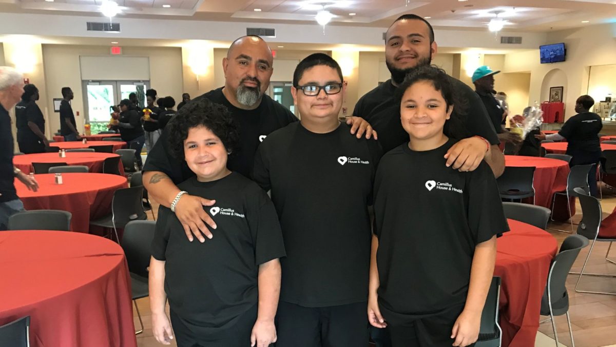 Family standing in black t-shirts