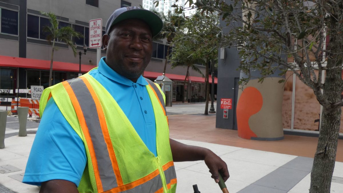 Man standing in vest smiling