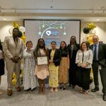 Staff takes a photo with recipients of Volunteer award