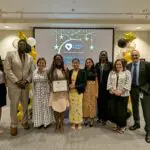 Staff takes a photo with recipients of Volunteer award