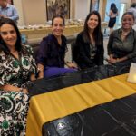 Female attendees smiling for a photo