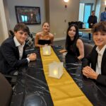 Teen volunteers take a photo together at the table.