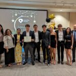 Staff takes a photo with recipients of Volunteer award