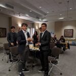 Male attendees clapping at the Volunteer Appreciation Event