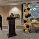 Former CEO Hilda Fernandez giving a speech at the podium