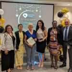 Staff takes a photo with recipient of Volunteer award