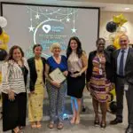 Staff takes a photo with recipient of Volunteer award