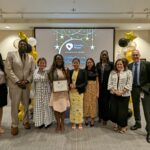 Staff takes a photo with recipients of Volunteer award